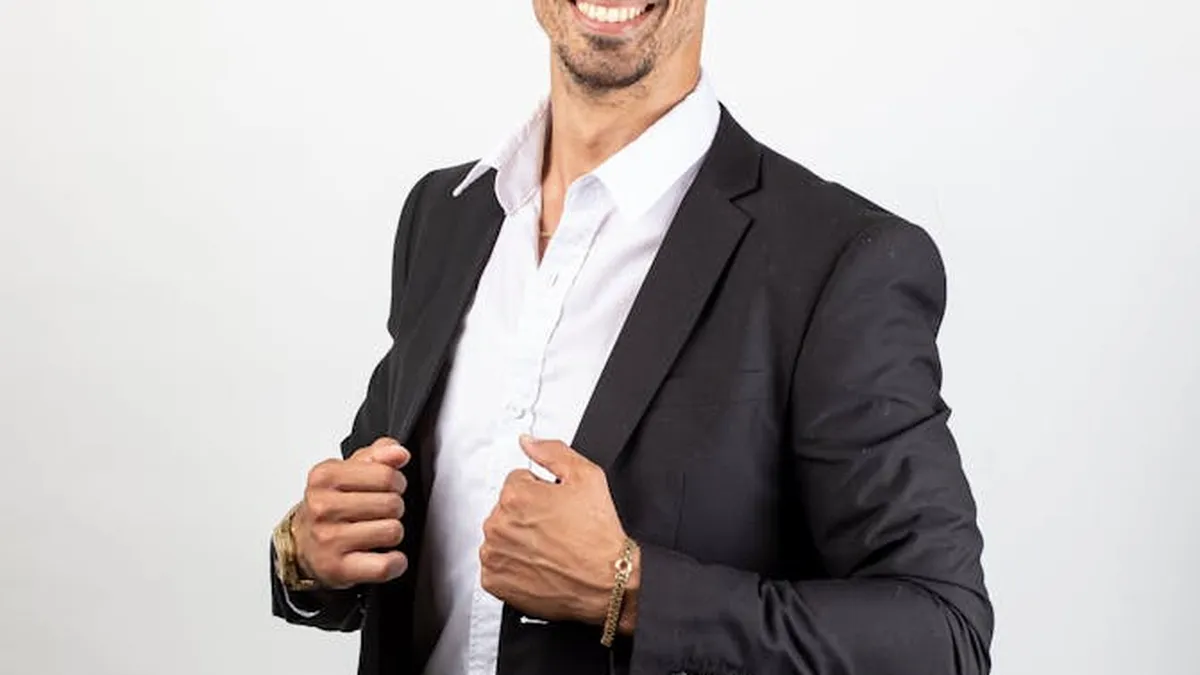 A confident businessman in a suit with a friendly smile, showcasing professionalism and success.
