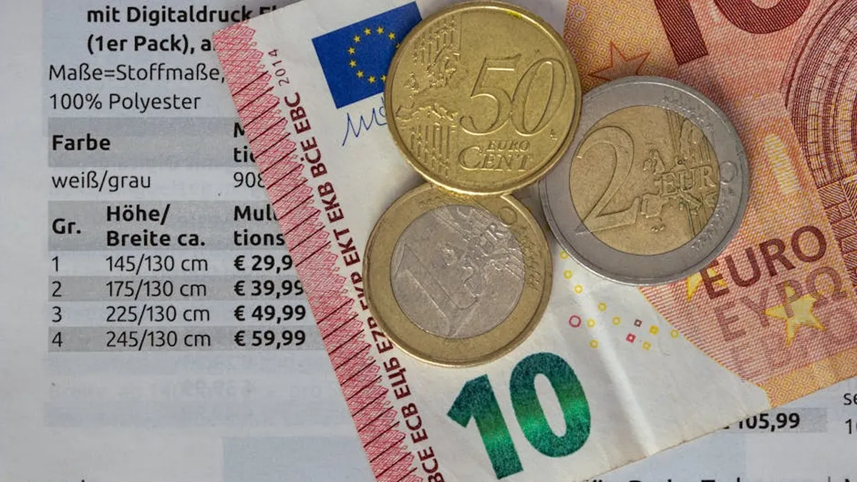 Euro coins and bills on a price list, symbolizing finance and economy.
