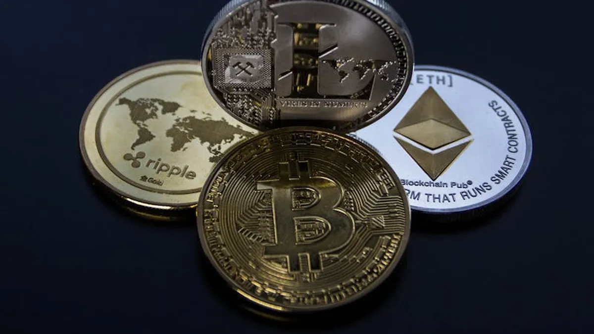 Detailed photo showcasing bitcoin, ethereum, litecoin, and ripple coins representing digital currency.
