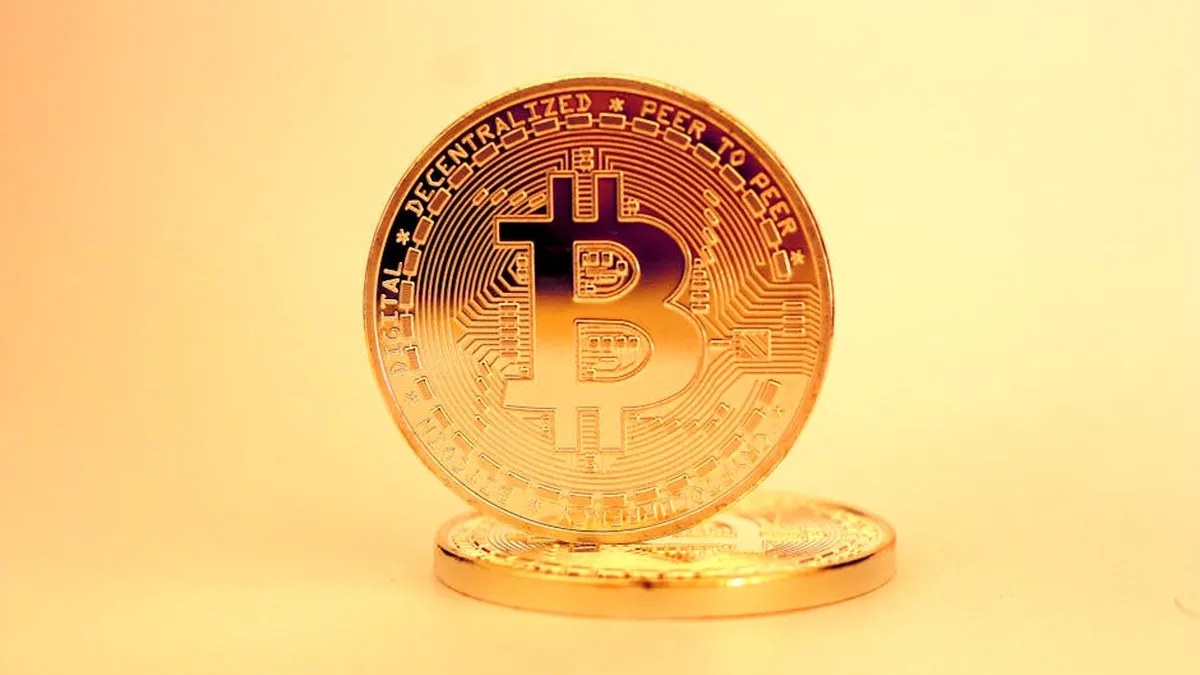 A close-up of a golden Bitcoin highlighting its digital currency design.