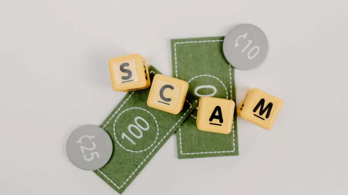 Yellow dice spelling 'Scam' on fake currency, representing financial deception.