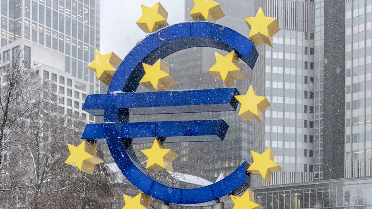 The iconic Euro symbol stands prominently amidst snowy Frankfurt skyscrapers.