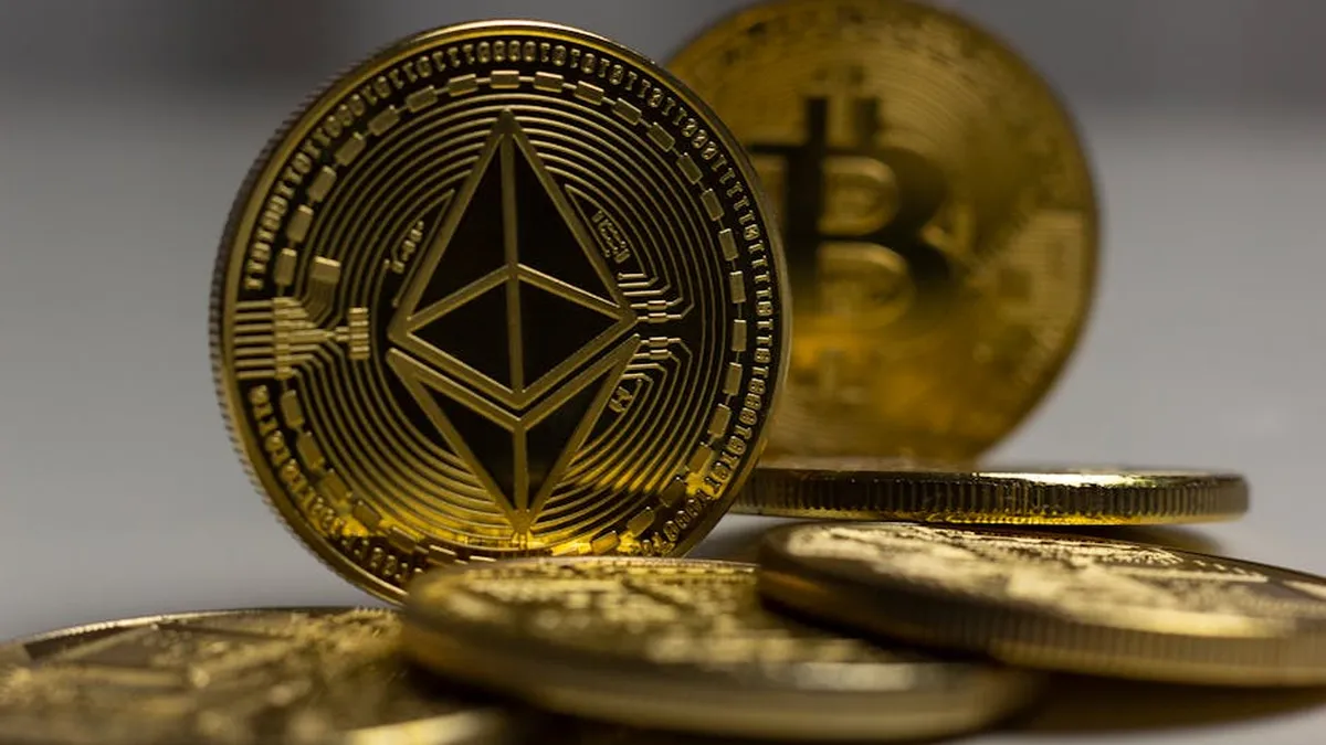 Detailed close-up shot of Ethereum and Bitcoin gold coins with a blurred background, signifying cryptocurrency.