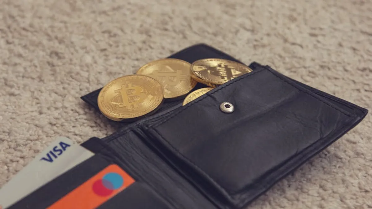 Close-up of bitcoins and credit cards inside a leather wallet, representing digital currency and finance.