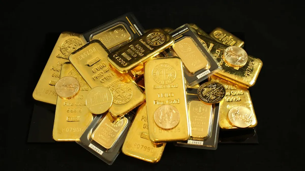 A collection of gold bars and coins symbolizing wealth and investment.