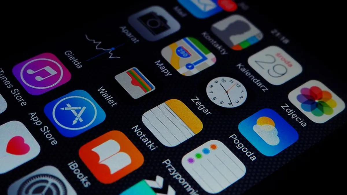 Close-up view of smartphone displaying various apps on the home screen.