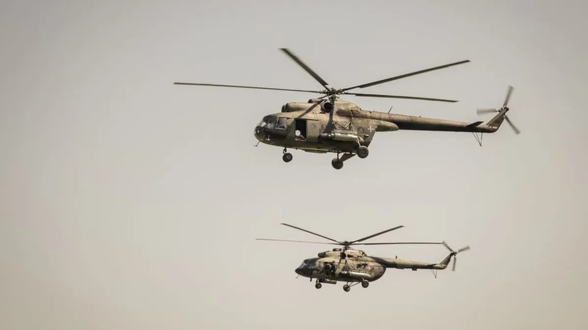 Two military helicopters flying in formation in the clear sky over Belgrade, showcasing aerial power.