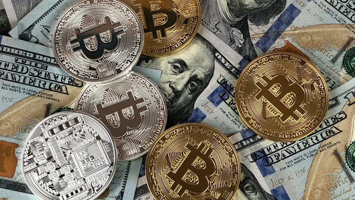Close-up of bitcoins and US dollar bills symbolizing modern finance and cryptocurrency.