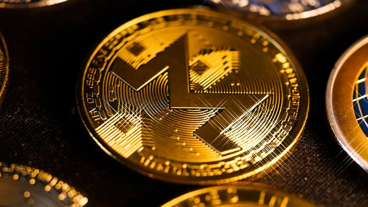 Shiny gold Monero coin close-up, focusing on digital currency aesthetics and investment potential.