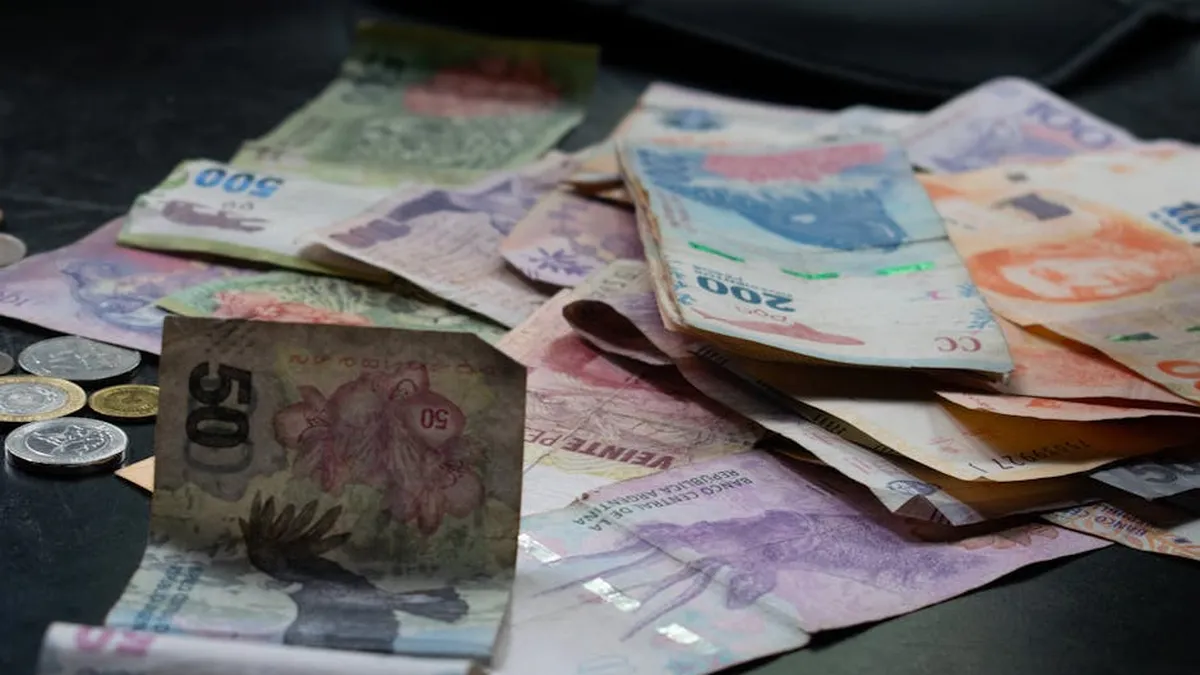 A mix of international banknotes and coins displayed on a table, highlighting diverse world currencies.