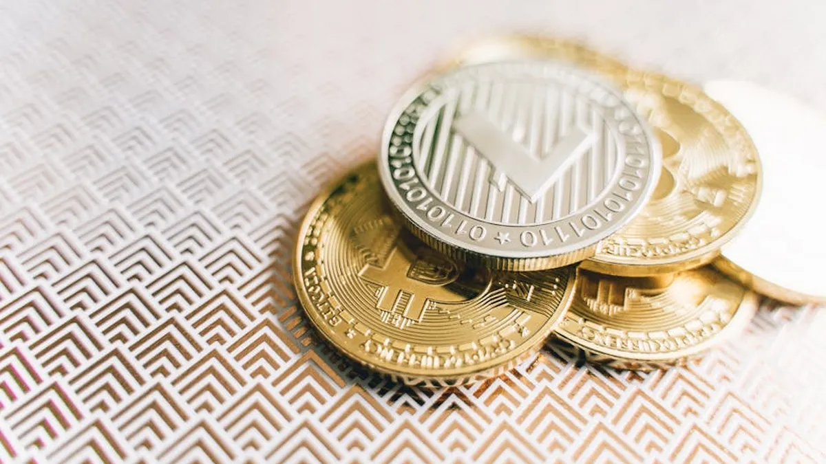 Stack of Bitcoin and Litecoin coins on a geometric textured surface, symbolizing digital finance.