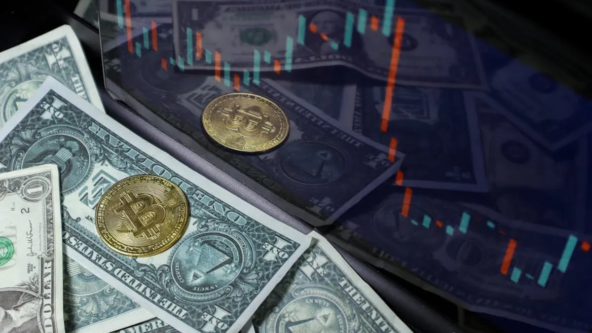 Bitcoin coin on US dollar bills with a stock market chart background. Represents cryptocurrency and finance.