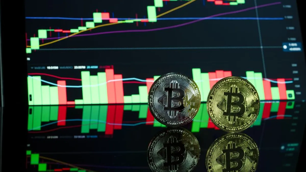 Bitcoin coins in front of a cryptocurrency trading chart showcasing market trends.